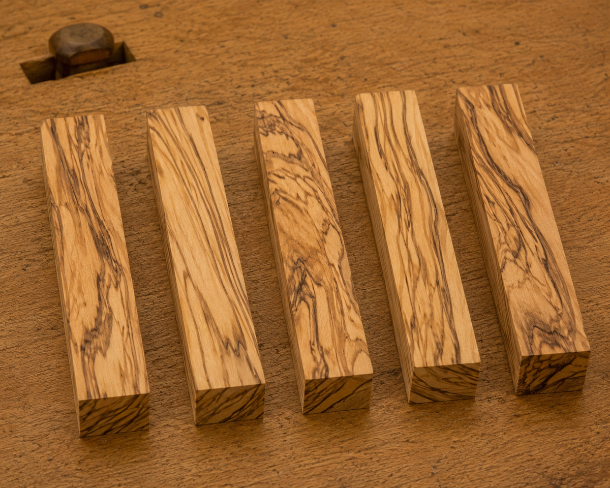 Olivewood pen blank showing wood grain detail, 3/4 x 3/4 x 5 inch
